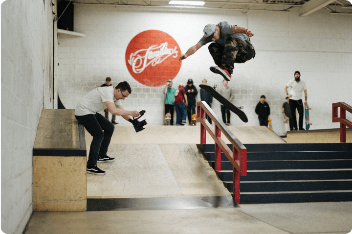 Me filming a flip trick down a set of stairs at Familia HQ Skatepark